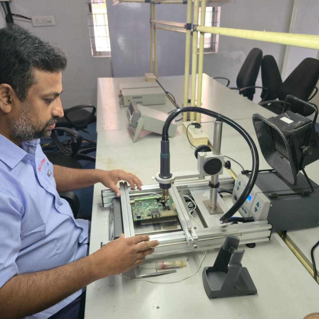 Star Automations technician at the SMD rework station with a microscope arm