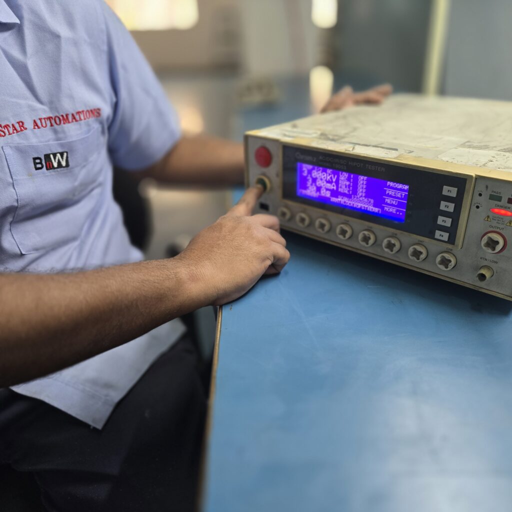Star Automations engineer running a hipot test on a bench tester