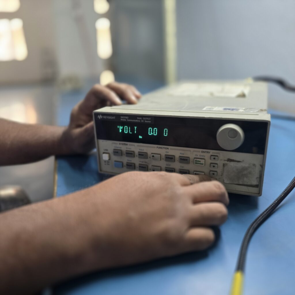 Star Automations engineer setting values on a programmable bench DC source