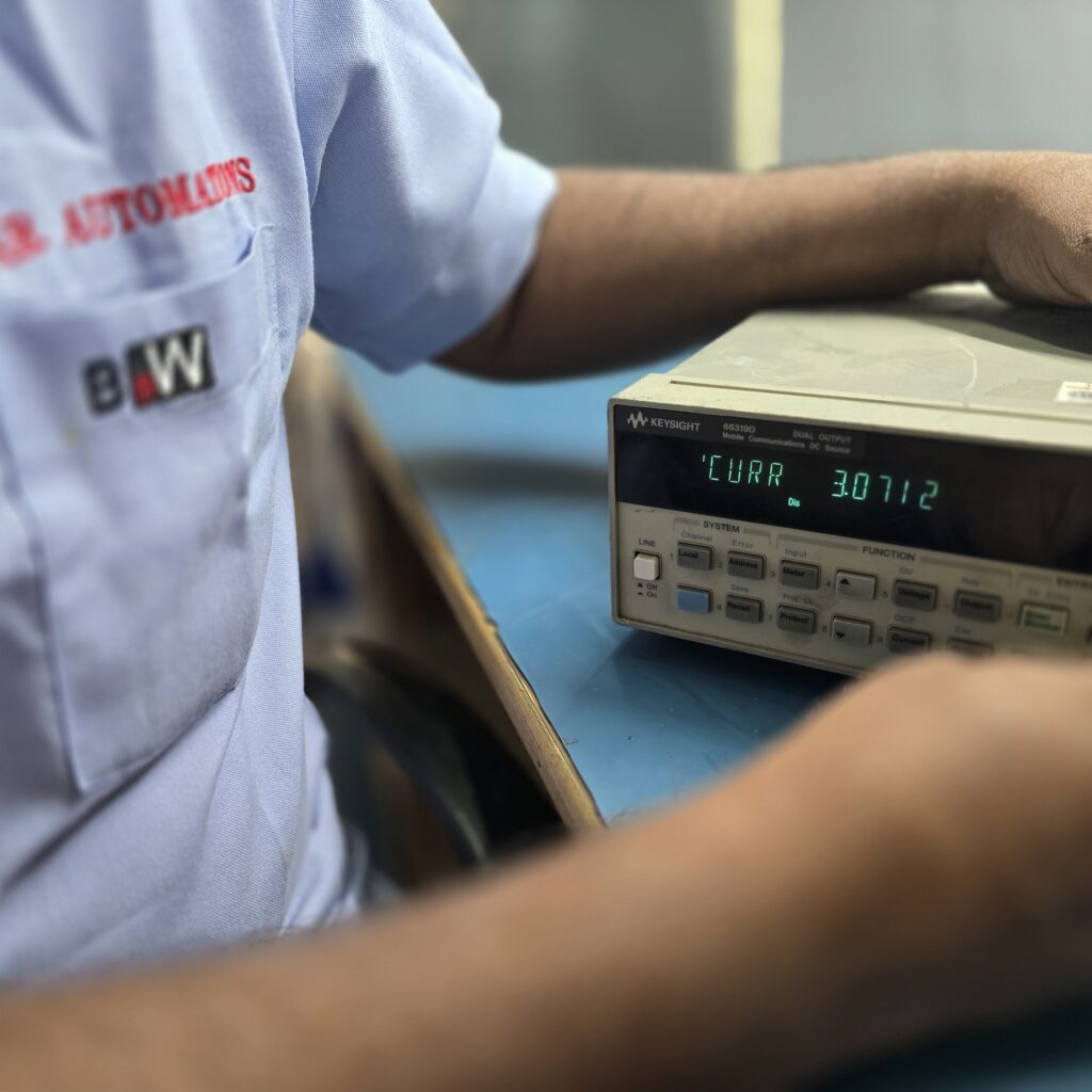 Star Automations technician operating a bench instrument during a functional check