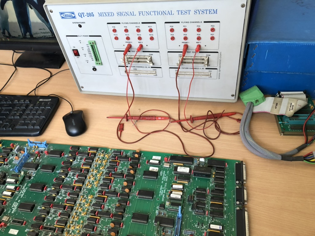 QMax QT-205 mixed-signal functional test system with test leads connected to an inverter control board on the repair bench