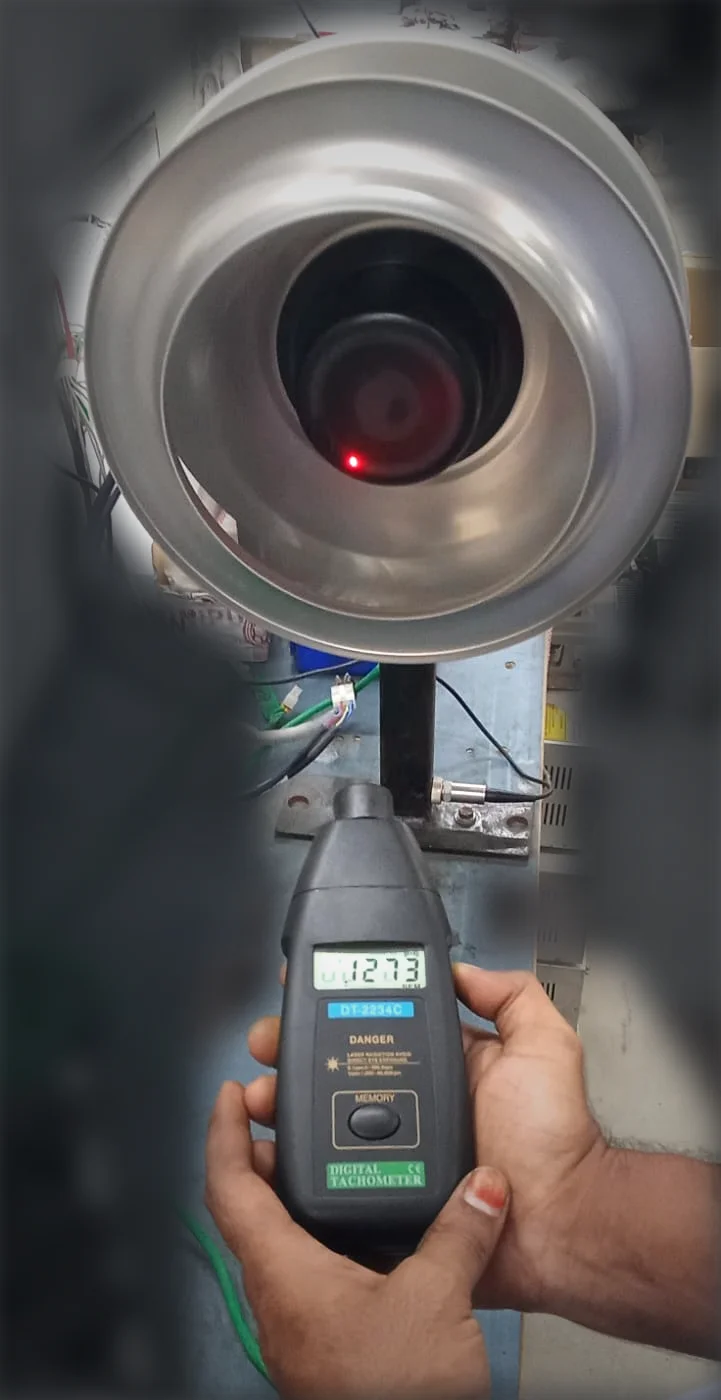 Blower impeller running on the balancing stand while a digital tachometer reads 1,273 rpm