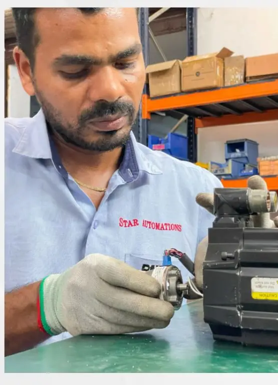 Technician working on a servo motor's feedback device at Star Automations