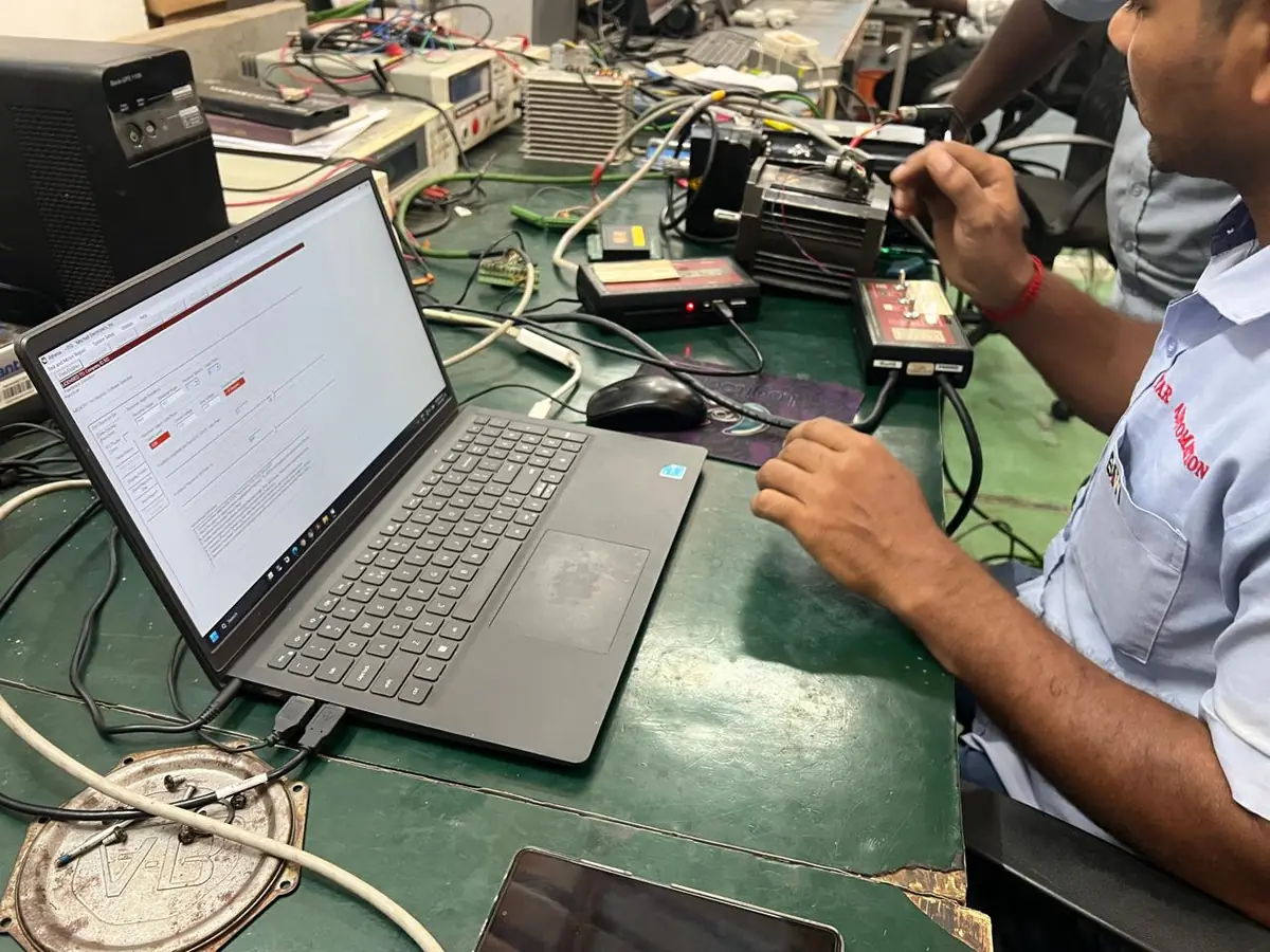 Servo motor repair in India: technician running a test at a Star Automations bench
